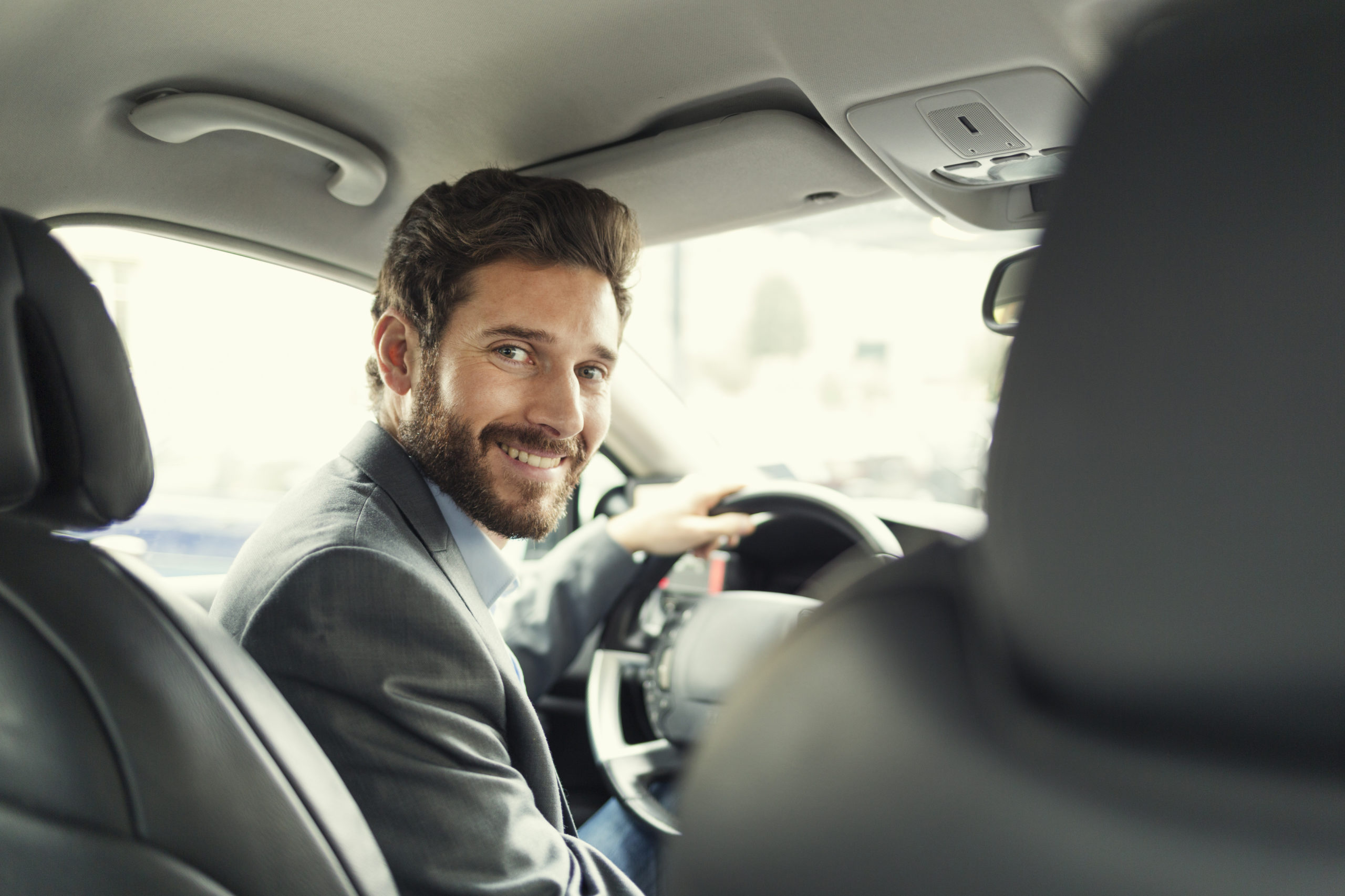 Portrait of man in his car. looking at camera